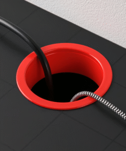 Red cable management grommet on IKEA MICKE desk