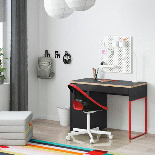 Red and black MICKE desk setup in a modern kids’ room