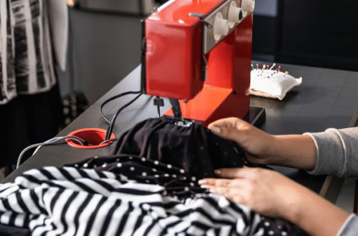 Sewing on a black and red MICKE desk with a red machine