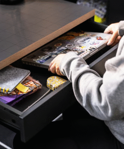 Pull-out drawer of red MICKE desk with laptop and supplies