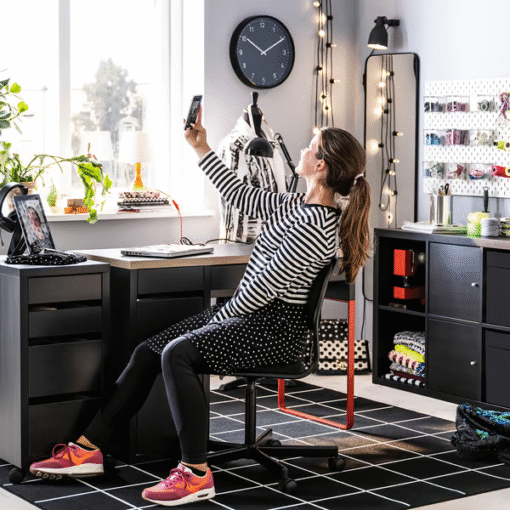 Woman using red and black IKEA MICKE desks in a creative home office
