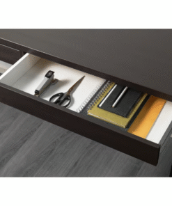 Open drawer of the MICKE desk in black-brown finish with organized office supplies