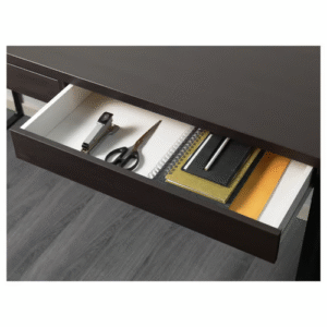 Open drawer of the MICKE desk in black-brown finish with organized office supplies