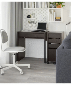 Black-brown IKEA MICKE desk in a modern living room workspace with white chair and wall-mounted storage