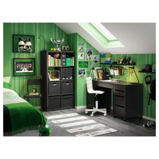 Black-brown desk in a green-themed kids’ room with bookshelves and white chair