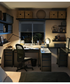 Black-brown desk setup in a cozy bedroom office with shelving and lighting